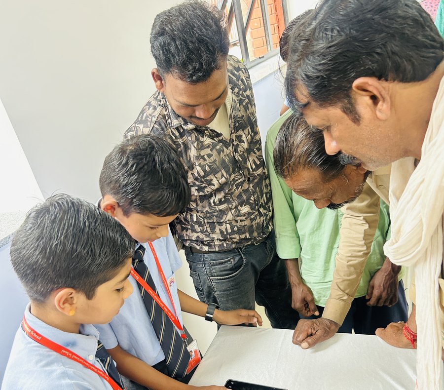 A Digital Gurukul session: a boy walking a visitor through his own phone at Birla Open Minds International School, Bhopal