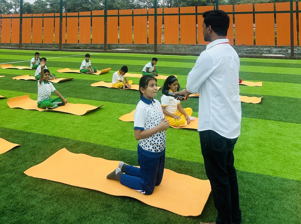 The teacher moving between the mats at Birla Open Minds International School, Bhopal