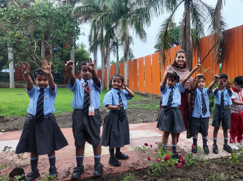 Sprinkling seed in the school garden at Birla Open Minds International School, Bhopal